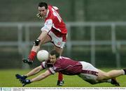 4 January 2004; Derek Heavin, Westmeath, attempts to block a kick by Louth's Alan McCarthy. O'Byrne Cup, Westmeath v Louth, Cusack Park, Mullingar, Co. Westmeath. Picture credit; Ray McManus / SPORTSFILE *EDI*