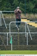 4 January 2004; A lone supporter attempts to warm his hands while listening to his radio. O'Byrne Cup, Carlow v Wicklow, Dr Cullen Park, Carlow. Picture credit; Brendan Moran / SPORTSFILE *EDI*