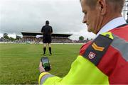 28 June 2013; Mick Curran, on duty with Order of Malta Carlow, looks at the time and date on his phone as the second half begins. GAA Football All-Ireland Senior Championship, Round 1, Carlow v Laois, Dr. Cullen Park, Carlow. Picture credit: Diarmuid Greene / SPORTSFILE
