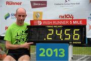 29 June 2013; Winner of the men's race Robbie Matthews, Dunshaughlin A.C., Co. Meath, with his winning time at the end of the Irish Runner 5 Mile. Airtricity Dublin Race Series, Phoenix Park, Dublin. Picture credit: David Maher / SPORTSFILE