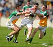 29 June 2013; Sean Cavanagh, Tyrone, in action against Eoin Carroll, left and Daithi Brady, Offaly. GAA Football All-Ireland Senior Championship, Round 1, Offaly v Tyrone, O'Connor Park, Tullamore, Co. Offaly. Picture credit: David Maher / SPORTSFILE
