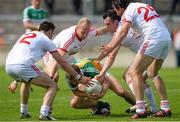 29 June 2013; Ciaran Hurley, Offaly, is tackled by, from left to right, Ryan McKenna, Danny McBride, Cathal McCarron and Joe McMahon, Tyrone. GAA Football All-Ireland Senior Championship, Round 1, Offaly v Tyrone, O'Connor Park, Tullamore, Co. Offaly. Picture credit: David Maher / SPORTSFILE