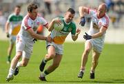 29 June 2013; Ken Casey, Offaly, in action against Conor Gormley, left and Danny McBride, Tyrone. GAA Football All-Ireland Senior Championship, Round 1, Offaly v Tyrone, O'Connor Park, Tullamore, Co. Offaly. Picture credit: David Maher / SPORTSFILE