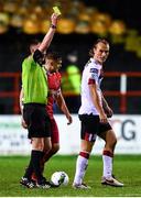 21 February 2020; Greg Sloggett of Dundalk receives a yellow card during the SSE Airtricity League Premier Division match between Shelbourne and Dundalk at Tolka Park in Dublin. Photo by Harry Murphy/Sportsfile