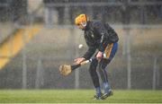 16 February 2020; Eibhear Quilligan of Clare attempts to dry his hurley  during the Allianz Hurling League Division 1 Group B Round 3 match between Clare and Laois at Cusack Park in Ennis, Clare. Photo by Eóin Noonan/Sportsfile