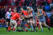 29 February 2020; Dan Goggin of Munster is tackled by Uzair Cassiem, left, and Aaron Shingler of Scarlets during the Guinness PRO14 Round 13 match between Munster and Scarlets at Thomond Park in Limerick. Photo by Ramsey Cardy/Sportsfile