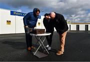 1 March 2020; Local hairdresser to the Clare players Abbas Chyad, left, of Panache Hair Design, Munster Council's Operations manager John Brennan and Clare PRO Michael O'Connor, right, watch a broadcast of the Dr. Harty Cup Final, on a smartphone, before the Allianz Hurling League Division 1 Group B Round 5 match between Clare and Dublin at Cusack Park in Ennis, Clare. Photo by Ray McManus/Sportsfile