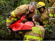 7 March 2020; Members of the Dublin Fire Brigade, Phibsborough Station, rescue a dog trapped on a Phoenix Park crag after he became trapped, from the Islandbridge roadside. Photo by Stephen McCarthy/Sportsfile