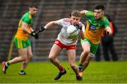 7 March 2020; Tiarnan Quinn of Tyrone in action against Eric Carr of Donegal during the EirGrid Ulster GAA Football U20 Championship Final match between Tyrone and Donegal at St Tiernach's Park in Clones, Monaghan. Photo by Oliver McVeigh/Sportsfile