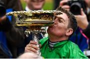 10 March 2020; Jockey Barry Geraghty celebrates with the cup after winning the Unibet Champion Hurdle Challenge Trophy on Epatante on Day One of the Cheltenham Racing Festival at Prestbury Park in Cheltenham, England. Photo by Harry Murphy/Sportsfile