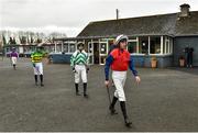 21 March 2020; Jockey Eoin Walsh, right, and fellow jockeys make their way to the parade ring, while maintaining social distancing, ahead of The Duggan Veterinary Handicap Steeplechase at Thurles Racecourse in Tipperary. Photo by Matt Browne/Sportsfile