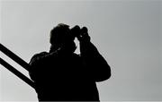 23 March 2020; A racecourse steward watches the action through his binoculars during the Irish Stallion Farms EBF Maiden at Naas Racecourse in Naas, Co Kildare. Photo by Seb Daly/Sportsfile