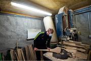31 March 2020; David Dowling shapes the hurl with a bandsaw during a feature on The Star Hurley in Jenkinstown, Kilkenny. Photo by Ramsey Cardy/Sportsfile