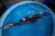 29 April 2020; Swimmer Mia Whelan-O'Connor of ESB Swimming Club swims in her back garden in an inflatable pool using a swimming parachute and a bungee cord, in Inchicore, Dublin. Photo by Ramsey Cardy/Sportsfile