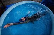 29 April 2020; Swimmer Mia Whelan-O'Connor of ESB Swimming Club swims in her back garden in an inflatable pool using a swimming parachute and a bungee cord, in Inchicore, Dublin. Photo by Ramsey Cardy/Sportsfile