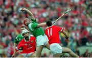 4 June 2000; Ollie Moran of Limerick gains possession under pressure from Fergal McCormack, 11, of Cork during the Guinness Munster Senior Hurling Championship Semi-Final match between Cork and Limerick at Semple Stadium in Thurles, Tipperary. Photo by Ray McManus/Sportsfile