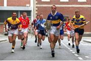 8 May 2002; Tipperary captain Thomas Dunne with the Liam MacCarthy cup is chased by 10 other county captains, including Larry O'Gorman of Wexford, Wayne Sherlock of Cork, Liam Hodgins of Galway, David Sweeney of Dublin, John Lyons of Laois, Joe Errity of Offaly, Mark Foley of Limerick, Fergal Hartley of Waterford, Andy Comerford of Kilkenny, and Brian Lohan of Clare at the launch of the Guinness All-Ireland Hurling Championship at the Guinness Storehorse in Dublin. Photo by Brendan Moran/Sportsfile