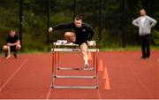 18 May 2020; Club member Alex Clarkin clears a hurdle watched by Jack Raftery and coach Paul Clarkin at Donore Harriers Athletic Club in Dublin as athletics resumes having previously suspended all activity following directives from the Irish Government in an effort to contain the spread of the Coronavirus (COVID-19). Athletics clubs in the Republic of Ireland resumed activity on May 18th under the Irish government’s Roadmap for Reopening of Society and Business following strict protocols of social distancing and hand sanitisation among others allowing it to return in a phased manner. Photo by Harry Murphy/Sportsfile