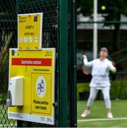 18 May 2020; A hand sanitising station is seen as club member Mary McCarthy participates in tennis at Malahide Lawn Tennis and Croquet Club in Dublin as tennis resumes having previously suspended all tennis activity following directives from the Irish Government in an effort to contain the spread of the Coronavirus (COVID-19). Tennis clubs in the Republic of Ireland resumed activity on May 18th under the Irish government’s Roadmap for Reopening of Society and Business following strict protocols of social distancing, hand sanitisation and marked tennis balls among others allowing tennis to return in a phased manner. Photo by Brendan Moran/Sportsfile