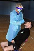 25 May 2020; Lu Kellett, Advanced Medical Services, conducts a COVID-19 swab test on Shamrock Rovers player Jack Byrne at their training facility, Roadstone Group Sports Club, in Dublin. Irish football took the first steps on the pathway to a safer return for all football when testing for COVID-19 began on Monday as part of the pilot programme and tournament for the four SSE Airtricity League clubs who will compete in Europe this year as Dundalk, Shamrock Rovers, Derry City and Bohemians prepare for a return to training. Players and staff from all four clubs were tested as the FAI continues to work on a pathway for a safer return for all Irish football in the coming months, under the supervision of Medical Director Dr Alan Byrne. Dr Byrne, a member of the Government’s Return to Sport expert group, has overseen the pilot programme for the four clubs that will inform all decisions on a pathway for Irish football to return in a safe environment by the end of August. The pilot tournament, featuring the four European qualified SSE Airtricity League teams, is planned for later this summer with the clubs scheduled to resume training on June 8th. Photo by Stephen McCarthy/Sportsfile