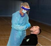 25 May 2020; Lu Kellett, Advanced Medical Services, conducts a COVID-19 swab test on Shamrock Rovers player Jack Byrne at their training facility, Roadstone Group Sports Club, in Dublin. Irish football took the first steps on the pathway to a safer return for all football when testing for COVID-19 began on Monday as part of the pilot programme and tournament for the four SSE Airtricity League clubs who will compete in Europe this year as Dundalk, Shamrock Rovers, Derry City and Bohemians prepare for a return to training. Players and staff from all four clubs were tested as the FAI continues to work on a pathway for a safer return for all Irish football in the coming months, under the supervision of Medical Director Dr Alan Byrne. Dr Byrne, a member of the Government’s Return to Sport expert group, has overseen the pilot programme for the four clubs that will inform all decisions on a pathway for Irish football to return in a safe environment by the end of August. The pilot tournament, featuring the four European qualified SSE Airtricity League teams, is planned for later this summer with the clubs scheduled to resume training on June 8th. Photo by Stephen McCarthy/Sportsfile