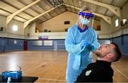 25 May 2020; Lu Kellett, Advanced Medical Services, conducts a COVID-19 swab test on Shamrock Rovers player Jack Byrne at their training facility, Roadstone Group Sports Club, in Dublin. Irish football took the first steps on the pathway to a safer return for all football when testing for COVID-19 began on Monday as part of the pilot programme and tournament for the four SSE Airtricity League clubs who will compete in Europe this year as Dundalk, Shamrock Rovers, Derry City and Bohemians prepare for a return to training. Players and staff from all four clubs were tested as the FAI continues to work on a pathway for a safer return for all Irish football in the coming months, under the supervision of Medical Director Dr Alan Byrne. Dr Byrne, a member of the Government’s Return to Sport expert group, has overseen the pilot programme for the four clubs that will inform all decisions on a pathway for Irish football to return in a safe environment by the end of August. The pilot tournament, featuring the four European qualified SSE Airtricity League teams, is planned for later this summer with the clubs scheduled to resume training on June 8th. Photo by Stephen McCarthy/Sportsfile