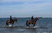 3 June 2020; Aili Leah on Lottieloveheart, right, and Leanne Breen on La Novia during a morning ride on Greencastle Beach in Greencastle, Co. Down. Horse racing is due to return behind closed doors on June 8, after racing was suspended in an effort to contain the spread of the Coronavirus (COVID-19) pandemic. Photo by Ramsey Cardy/Sportsfile