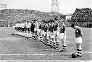 24 May 1964; Republic of Ireland players, from right to left, Joe Haverty, Millwall, Paddy Ambrose, Shamrock Rovers, Willie Browne, Bohemians, Eddie Bailham, Shamrock Rovers, Tony Dunne, Manchester United, Johnny Giles, Leeds United, Andy McEvoy, Blackburn Rovers, Mick McGrath, Blackburn Rovers, Fred Strahan, Shelbourne, Noel Dwyer, Swansea Town, and captain Noel Cantwell, Manchester United, stand for the National Anthem before the game. International Friendly, Republic of Ireland v England, Dalymount Park, Dublin. Photo by Connolly Collection/Sportsfile