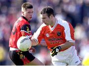 9 June 2001; Enda McNulty Armagh, clears under pressure from Ronan Murtagh, Down. Bank of Ireland All- Ireland Football Championship, Down v Armagh, Casement Park, Belfast. Photo by Ray McManus/Sportsfile
