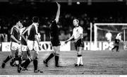 11 June 1990; Steve McMahon of England is shown a yellow card by referee Aron Schmidhuber during the FIFA World Cup 1990 Group F match between England and Republic of Ireland at Stadio Sant'Elia in Cagliari, Italy. Photo by Ray McManus/Sportsfile