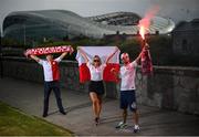 14 June 2020; Poland supporters, from left, Pawel Cherek, from Ongar, Dublin, Magda Boruc and Bart Boruc, both from Naas, Kildare, pose for a portrait near the Aviva Stadium in Dublin. Monday 15 June 2020 was the scheduled date for the opening game in Dublin of UEFA EURO 2020, the Group E opener between Poland and Play-off B Winner. UEFA EURO 2020, to be held in 12 European cities across 12 UEFA countries, was originally scheduled to take place from 12 June to 12 July 2020. On 17 March 2020, UEFA announced that the tournament would be delayed by a year due to the COVID-19 pandemic in Europe, and proposed it take place from 11 June to 11 July 2021. Photo by Stephen McCarthy/Sportsfile