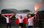 14 June 2020; Poland supporters, from left, Pawel Cherek, from Ongar, Dublin, Magda Boruc and Bart Boruc, both from Naas, Kildare, pose for a portrait near the Aviva Stadium in Dublin. Monday 15 June 2020 was the scheduled date for the opening game in Dublin of Euro 2020, the Group E opener between Poland and Play-off B Winner. UEFA EURO 2020, to be held in 12 European cities across 12 UEFA countries, was originally scheduled to take place from 12 June to 12 July 2020. On 17 March 2020, UEFA announced that the tournament would be delayed by a year due to the COVID-19 pandemic in Europe, and proposed it take place from 11 June to 11 July 2021. Photo by Stephen McCarthy/Sportsfile