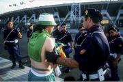17 June 1990; A Republic of Ireland supporter is checked by police outside the stadium prior to the FIFA World Cup 1990 Group F match between Republic of Ireland and Egypt at Stadio La Favorita in Palermo, Italy. Photo by Ray McManus/Sportsfile
