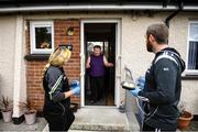 17 June 2020; Grainne O'Neill and Sean Owens, members of St. Canice’s GAA club in Dungiven, Derry, deliver a hot dinner to Bernie O’Neill, a member of the local community, as GAA clubs nationwide help out their local communities during restrictions imposed by the Irish and British Governments in an effort to contain the spread of the Coronavirus (COVID-19) pandemic. GAA facilities reopened on Monday June 8 for the first time since March 25 with club matches provisionally due to start on July 31 and intercounty matches due to to take place no sooner that October 17. Photo by Stephen McCarthy/Sportsfile