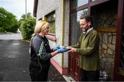 17 June 2020; Grainne O'Neill, a member of St. Canice’s GAA club in Dungiven, Derry, delivers a hot dinner to Neil O’Kane, a member of the local community, as GAA clubs nationwide help out their local communities during restrictions imposed by the Irish and British Governments in an effort to contain the spread of the Coronavirus (COVID-19) pandemic. GAA facilities reopened on Monday June 8 for the first time since March 25 with club matches provisionally due to start on July 31 and intercounty matches due to to take place no sooner that October 17. Photo by Stephen McCarthy/Sportsfile