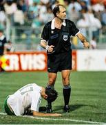 21 June 1990; Referee Michel Vautrot calls for medical assistance for Niall Quinn Republic of Ireland during the FIFA World Cup 1990 Group F match between Republic of Ireland and Netherlands at Stadio La Favorita in Palermo, Italy. Photo by Ray McManus/Sportsfile