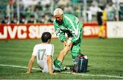 21 June 1990; Niall Quinn of Republic of Ireland is attended to by team physio Mick Byrne during the FIFA World Cup 1990 Group F match between Republic of Ireland and Netherlands at Stadio La Favorita in Palermo, Italy. Photo by Ray McManus/Sportsfile