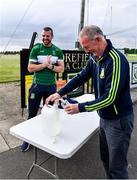 24 June 2020; Moorefield manager Ronan Sweeney, behind, applies hand sanitiser as Pat Flynn, member of Moorefield Executive, refills the bottles before a Moorefield Senior Football Squad training session at Moorefield GAA club in Newbridge, Kildare. Following approval from the GAA and the Irish Government, the GAA released its safe return to play protocols, allowing pitches to be opened for non contact training on 24 June and for training and challenge games to resume from 29 June. On March 25, the GAA announced the cessation of all GAA activities and closures of all GAA facilities under their jurisdiction upon directives from the Irish Government in an effort to contain the Coronavirus (COVID-19) pandemic. Photo by Piaras Ó Mídheach/Sportsfile