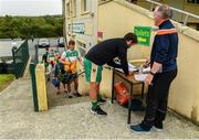 25 June 2020; Paul Gallagher, team officials, completing health forms and sanitizing the officals and players before a Glenswilly GAA Club training session at Glenkerragh in Donegal. Following approval from the GAA and the Irish Government, the GAA released its safe return to play protocols, allowing pitches to be opened for non contact training on 24 June and for training and challenge games to resume from 29 June. On March 25, the GAA announced the cessation of all GAA activities and closures of all GAA facilities under their jurisdiction upon directives from the Irish Government in an effort to contain the Coronavirus (COVID-19) pandemic. Photo by Oliver McVeigh/Sportsfile