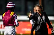 26 June 2020; Katie Harrington, daughter of trainer Jessica Harrington, takes a photo of jockey Shane Foley ahead of the TRM Fillies Handicap during day one of the Dubai Duty Free Irish Derby Festival at The Curragh Racecourse in Kildare. Horse Racing continues behind closed doors following strict protocols having been suspended from March 25 due to the Irish Government's efforts to contain the spread of the Coronavirus (COVID-19) pandemic. Photo by Harry Murphy/Sportsfile