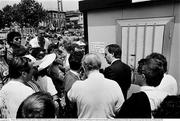 25 June 1990; FAI official Donie Butler speaks to Republic of Ireland supporters as they queue for match tickets prior to the FIFA World Cup 1990 Round of 16 match between Republic of Ireland and Romania at the Stadio Luigi Ferraris in Genoa, Italy. Photo by Ray McManus/Sportsfile