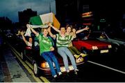 1 July 1990; Republic of Ireland supporters cheer on their team as they are brought by open top bus from Dublin Airport to College Green in Dublin city centre on their arrival home for a homecoming reception after their participation in the 1990 FIFA World Cup Finals in Italy. Photo by Ray McManus/Sportsfile