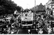 1 July 1990; The Republic of Ireland squad are cheered by supporters as they are brought by open top bus through Drumcondra to College Green in Dublin city centre on their arrival home for a homecoming reception after their participation in the 1990 FIFA World Cup Finals in Italy. Photo by Ray McManus/Sportsfile