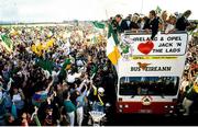 1 July 1990; Members of the Republic of Ireland squad, including Kevin Moran and Mick McCarthy, are cheered by supporters as they are brought by open top bus from Dublin Airport to College Green in Dublin city centre on their arrival home for a homecoming reception after their participation in the 1990 FIFA World Cup Finals in Italy. Photo by Ray McManus/Sportsfile