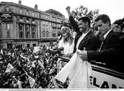 1 July 1990; The Republic of Ireland squad, including Paul McGrath and Mick McCarthy are cheered by supporters as they are brought by open top bus from Dublin Airport to College Green in Dublin city centre on their arrival home for a homecoming reception after their participation in the 1990 FIFA World Cup Finals in Italy. Photo by Ray McManus/Sportsfile