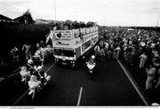 1 July 1990; The Republic of Ireland squad open top bus makes it's way over the central reservation of the motorway from Dublin Airport to College Green in Dublin city centre while being cheered by supporterson their arrival home for a homecoming reception after their participation in the 1990 FIFA World Cup Finals in Italy. Photo by Ray McManus/Sportsfile