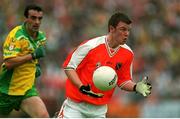 8 July 2002; Ronan Clarke, Armagh, in action against Jim McGuinness, Donegal. Armagh v Donegal, Ulster Football Final, St Tighearnachs Park, Clones, Co. Monaghan. Photo by David Maher/Sportsfile