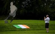 11 July 2020; A member of the public photographs a tribute that is placed outside the FAI Headquarters in Abbotstown, Dublin, as a mark of respect to the passing of former Republic of Ireland manager Jack Charlton, who lead the Republic of Ireland team to their first major finals at UEFA Euro 1988, and subsequently the FIFA World Cup 1990, in Italy, and the FIFA World Cup 1994, in USA. Photo by Stephen McCarthy/Sportsfile