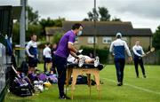 18 July 2020; Faythe Harriers physio Craig Hore attending to a players ahead of the Wexford County Senior Hurling Championship Group B Round 1 match between Ferns St Aidan's and Faythe Harriers at Bellefield in Enniscorthy, Wexford. Competitive GAA matches have been approved to return following the guidelines of Phase 3 of the Irish Government’s Roadmap for Reopening of Society and Business and protocols set down by the GAA governing authorities. With games having been suspended since March, competitive games can take place with updated protocols including a limit of 200 individuals at any one outdoor event, including players, officials and a limited number of spectators, with social distancing, hand sanitisation and face masks being worn by those in attendance among other measures in an effort to contain the spread of the Coronavirus (COVID-19) pandemic. Photo by Eóin Noonan/Sportsfile
