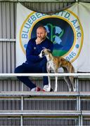 19 July 2020; Wayne Groves from Drogheda, Louth, and his greyhound, Quill, watch on from the stands during the Leinster Senior League Senior Sunday Division match between Bluebell United and Ballymun United at Capco Park in Bluebell, Dublin.  Photo by Sam Barnes/Sportsfile